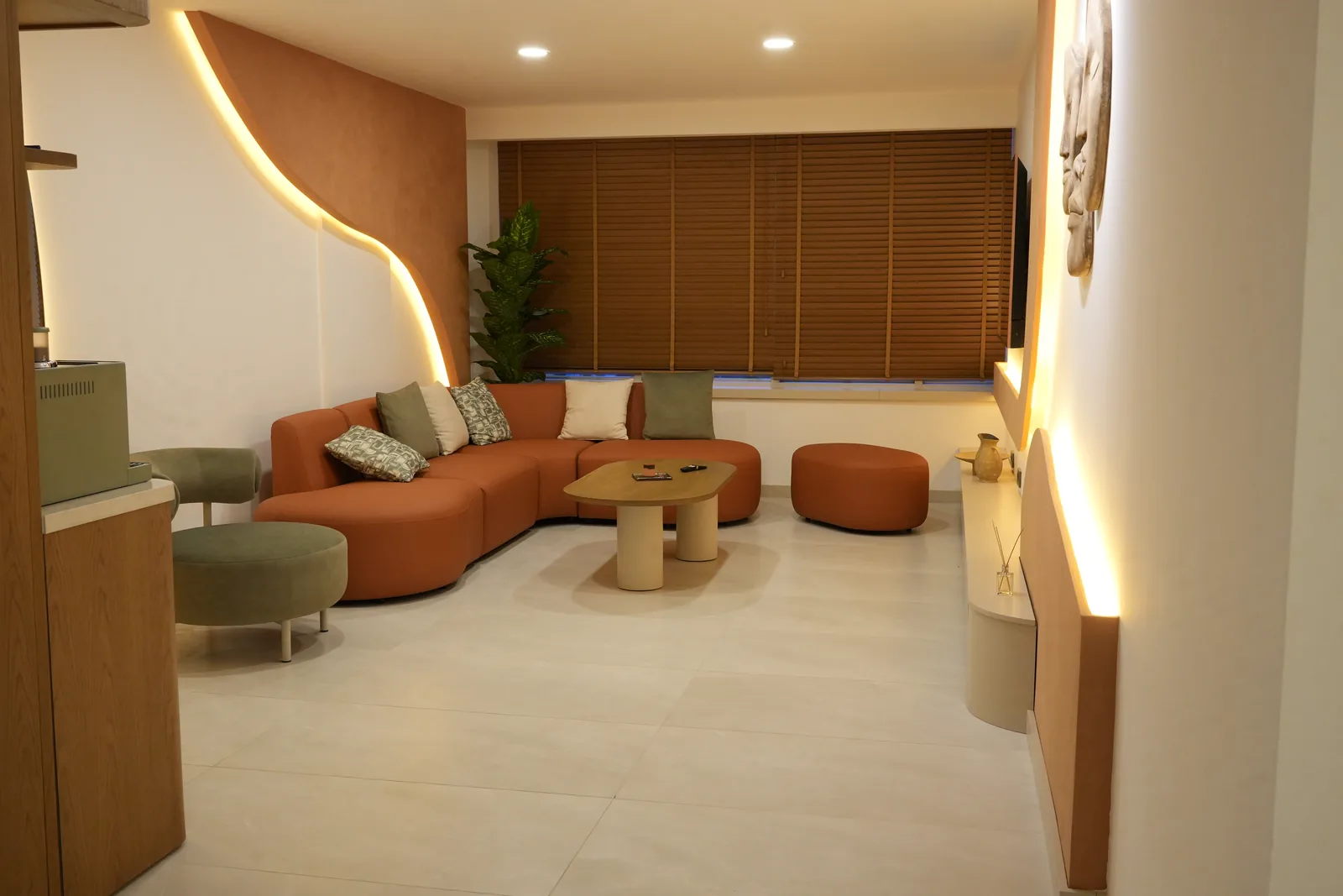 Waiting lounge of Op. Dr. Aytac Kilic's practice in Antalya — terracotta modular seating and concealed lighting